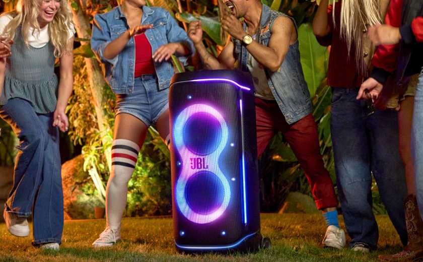 JBL PartyBox 720 in a yard with people dancing around it while its zoomed in