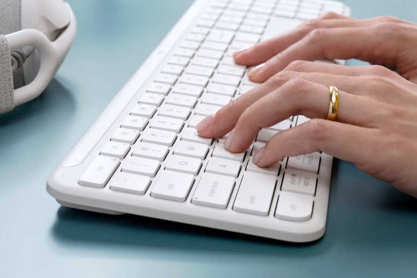 Person typing on a keyboard.