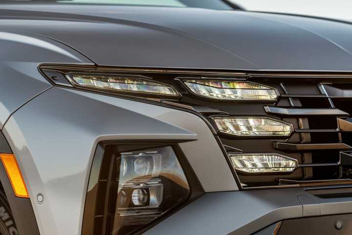 Close-up of the friont end of a gray 2025 Hyundai Tucson PHEV.