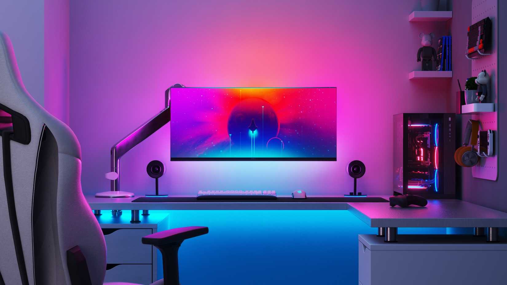 PC gaming setup with bias lighting behind the monitor.