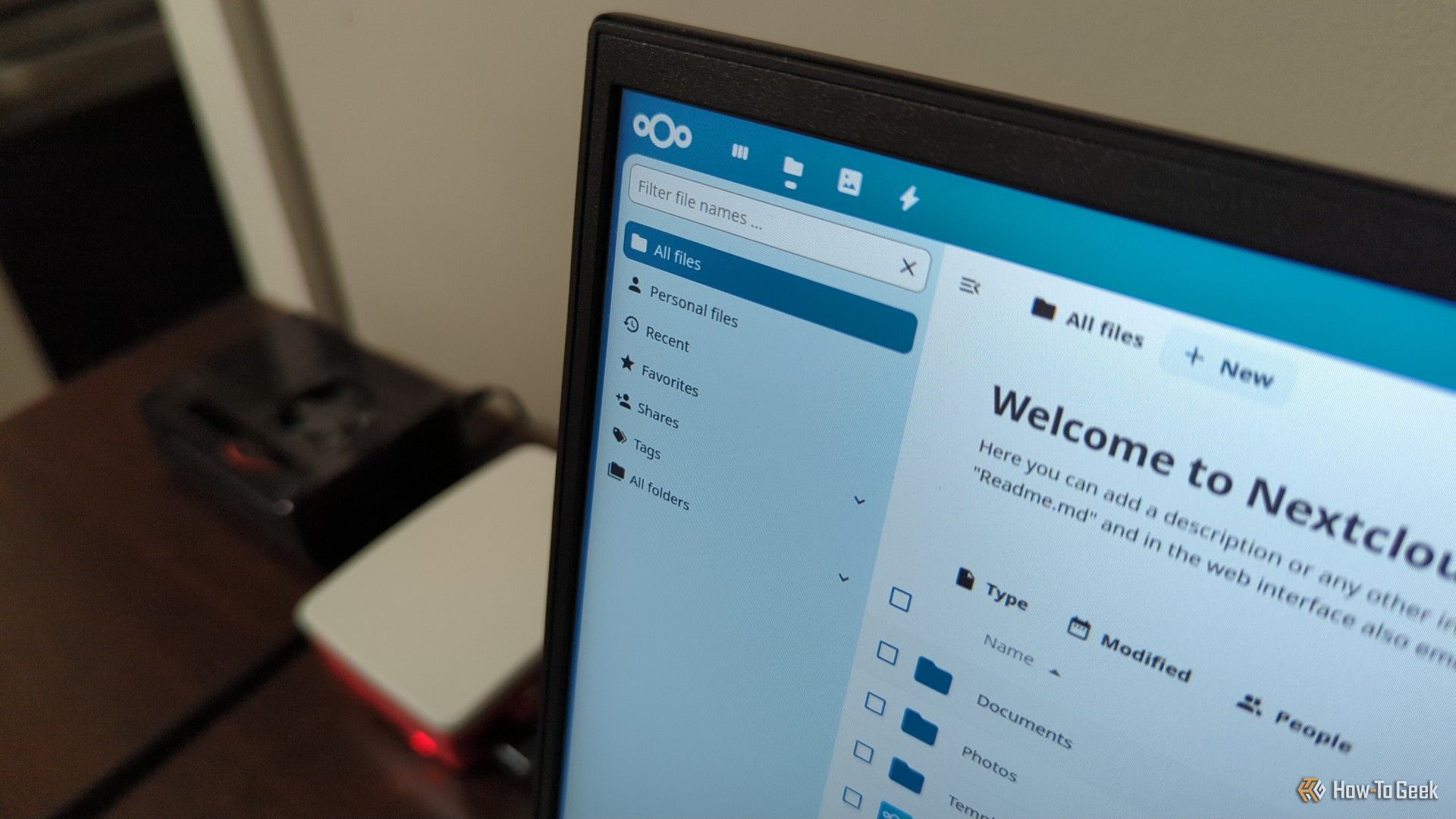 Nextcloud interface on a laptop screen with two Raspberry Pi devices in the background.