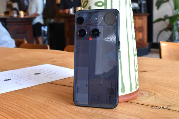 nothing phone 3 rear panel wide shot in cafe.