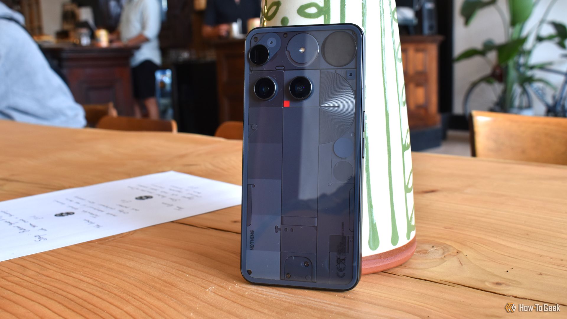 nothing phone 3 rear panel wide shot in cafe.