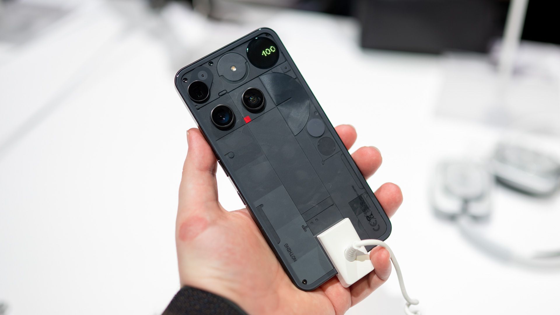 Person holding the Nothing Phone 3 showing the entire back.