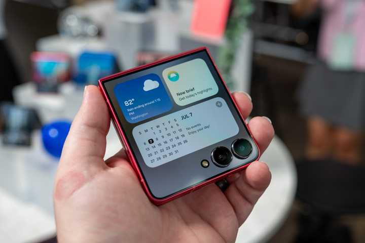 person holding the samsung galaxy z flip 7 showing widgets on the cover display 54642055506 o-1
