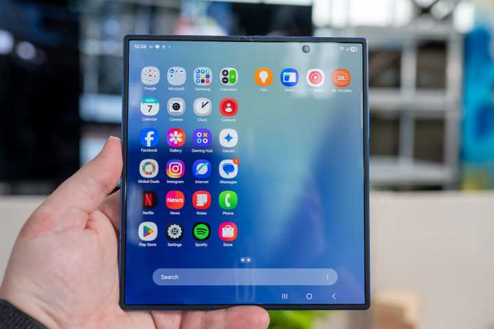 person holding the samsung galaxy z fold 7 unfolded showing the app drawer on the inside display 54642360950 o