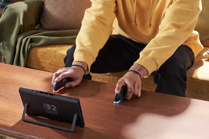 Person playing Nintendo Switch 2 in dual mouse mode