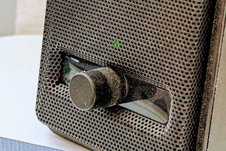 Close-up on a dusty computer speaker.