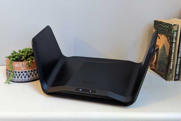 The Netgear Nighthawk RAX300 router on a bookshelf.