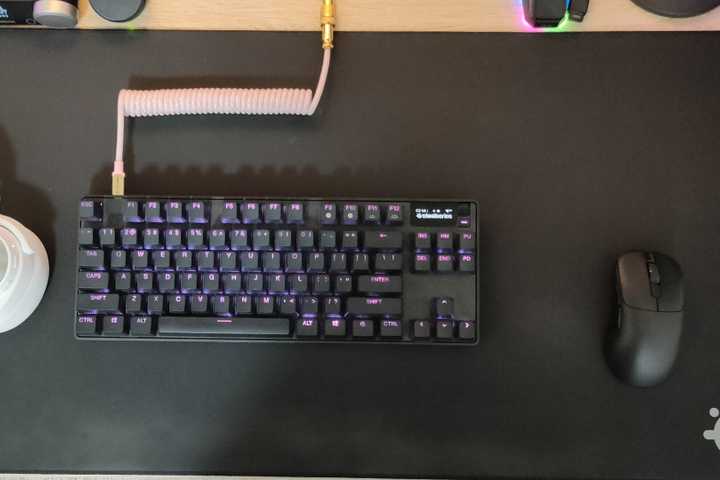 The SteelSeries QCK Performance Speed gaming mousepad with a SteelSeries keyboard and an Ajazz mouse on it.