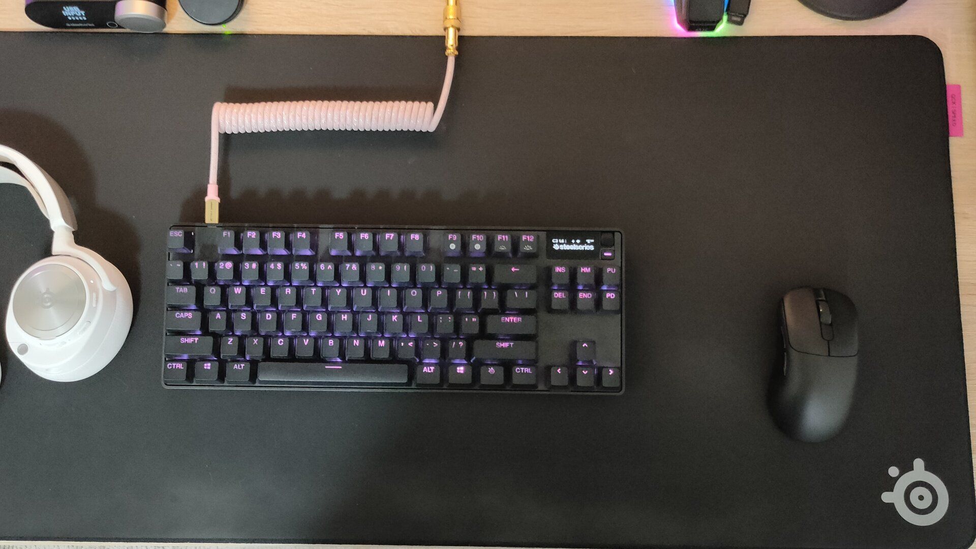 The SteelSeries QCK Performance Speed gaming mousepad with a SteelSeries keyboard and an Ajazz mouse on it.