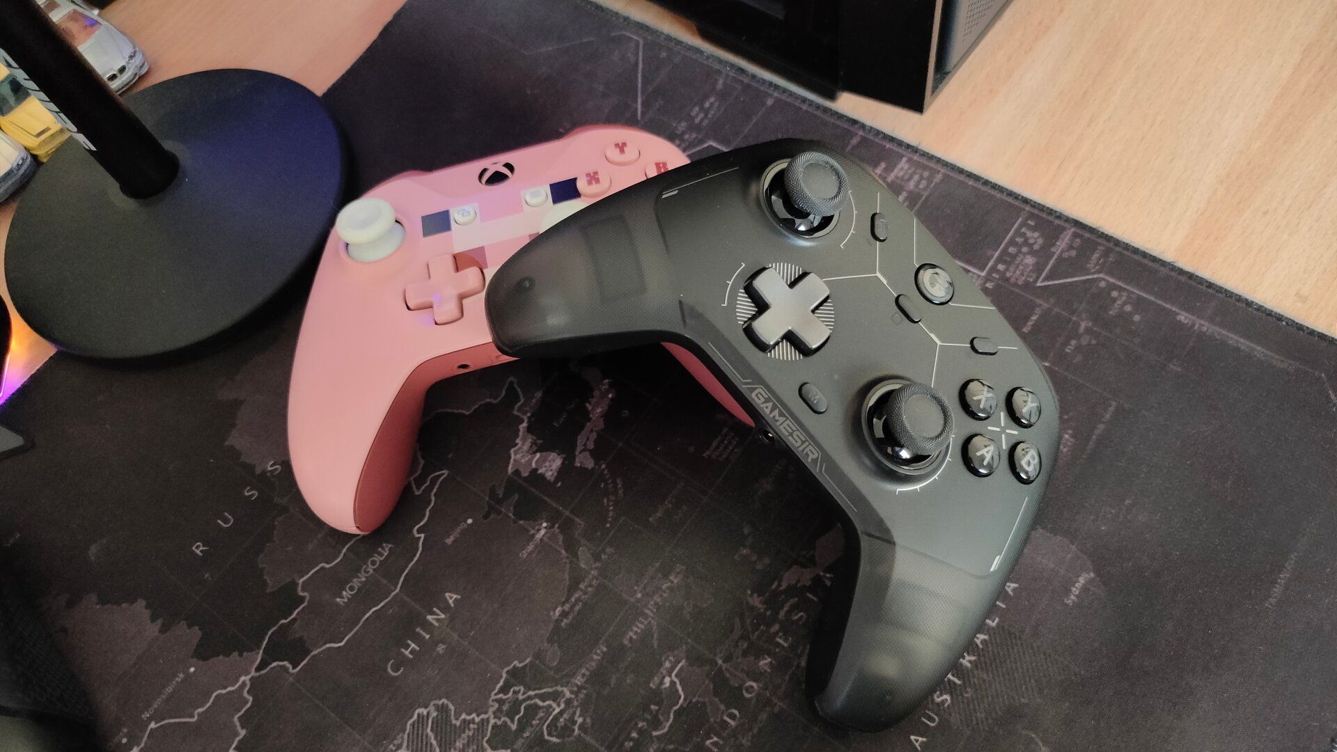 The GameSir Cyclone 2 controller on top of a pink Minecraft Pig Xbox One controller.