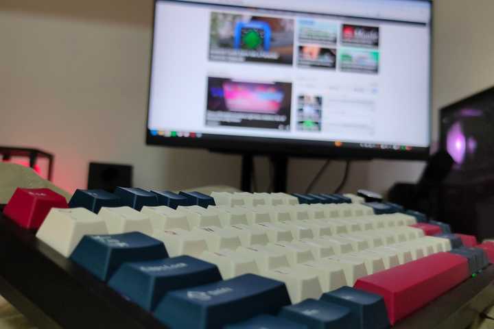 A wireless mechanical keyboard on a lap.