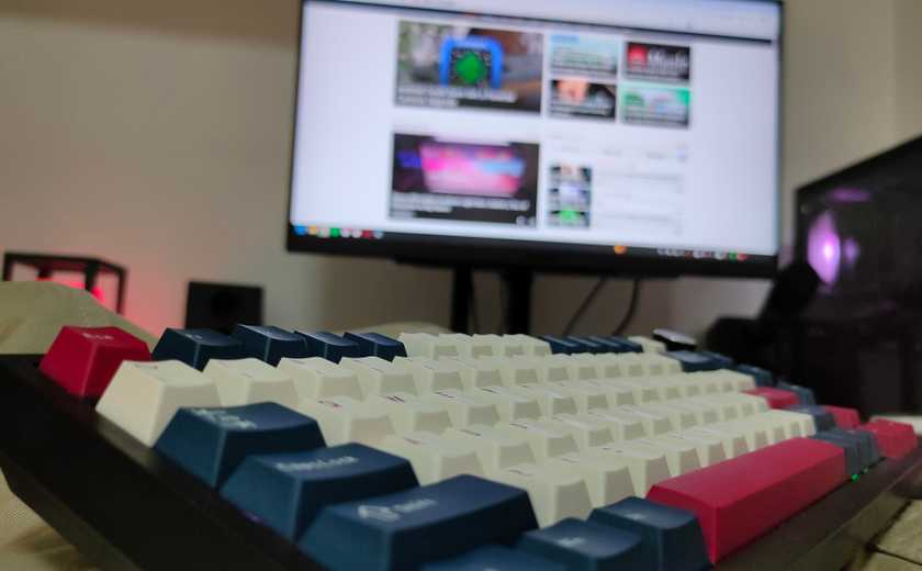 A wireless mechanical keyboard on a lap.
