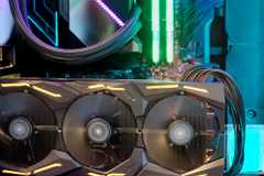 Closeup of a GPU operating inside a PC gaming rig with RGB lighting.