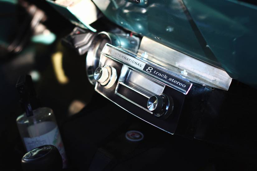 A vintage 8 track player at a classic car show.