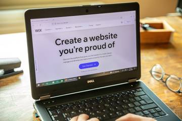 Laptop screen with the Wix website builder visible in the browser window.