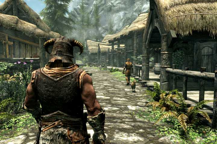 The main character walking down a road in Riverrun in The Elder Scrolls V: Skyrim.