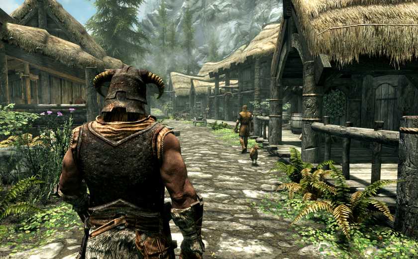 The main character walking down a road in Riverrun in The Elder Scrolls V: Skyrim.
