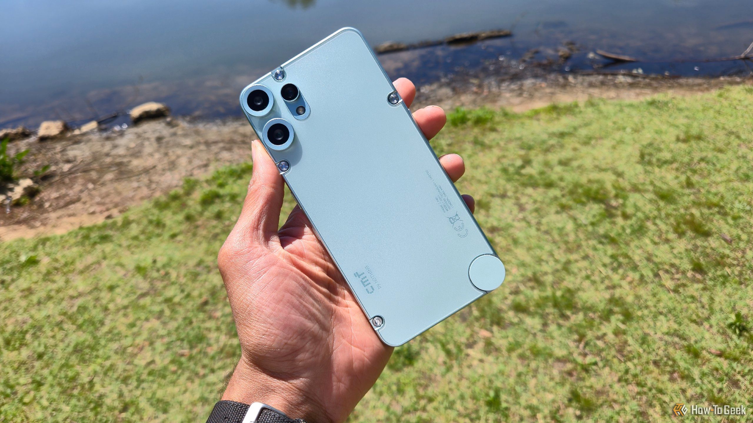 The CMF Phone 2 Pro in front of a lake.