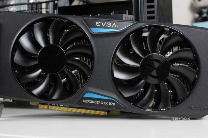The EVGA NVIDIA GeForce GTX 970 SSC GAMING ACX 2.0 graphics card sitting on a desk.