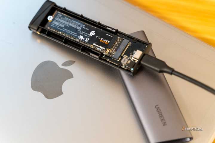 UGREEN M.2 NVMe SSD USB-C Enclosure with WD_BLACK SN750 SSD Inside Sitting on a MacBook.
