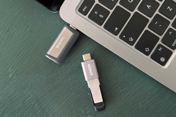 USB Flash drives next to a MacBook.