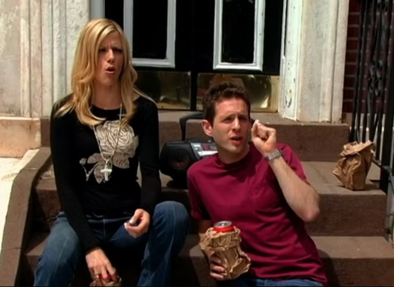 Dennis and Dee sitting on steps in the Dennis and Dee Go On Welfare episode.