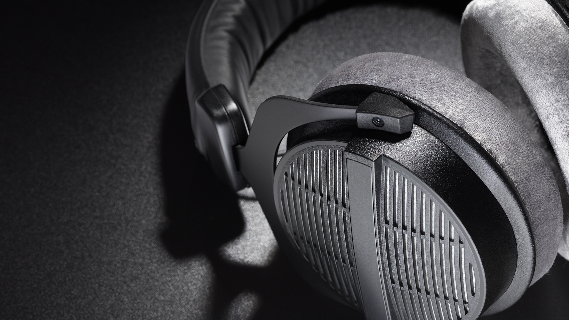 open-back headphones on a surface.