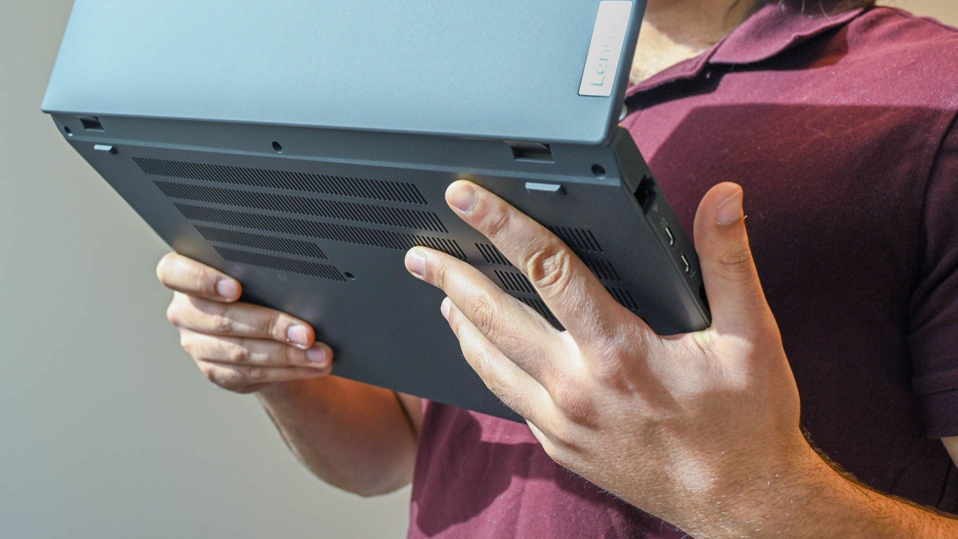 A person holding the Lenovo ThinkPad T16 Gen 1 to show the vents