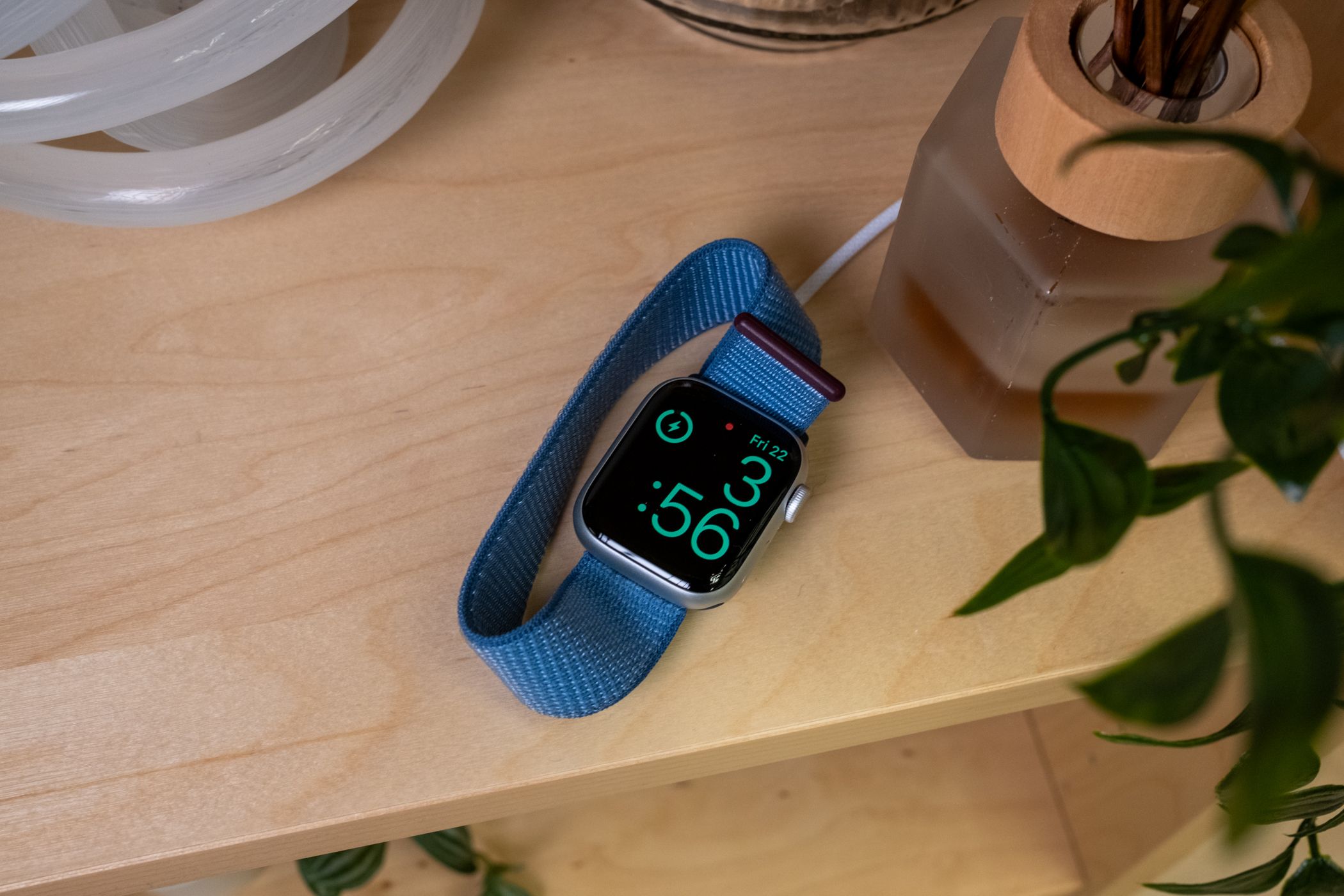 Charging the Apple Watch Series 9 on a table.
