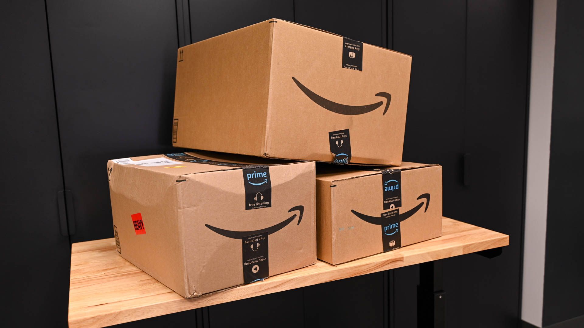 A stack of Amazon boxes on a table.