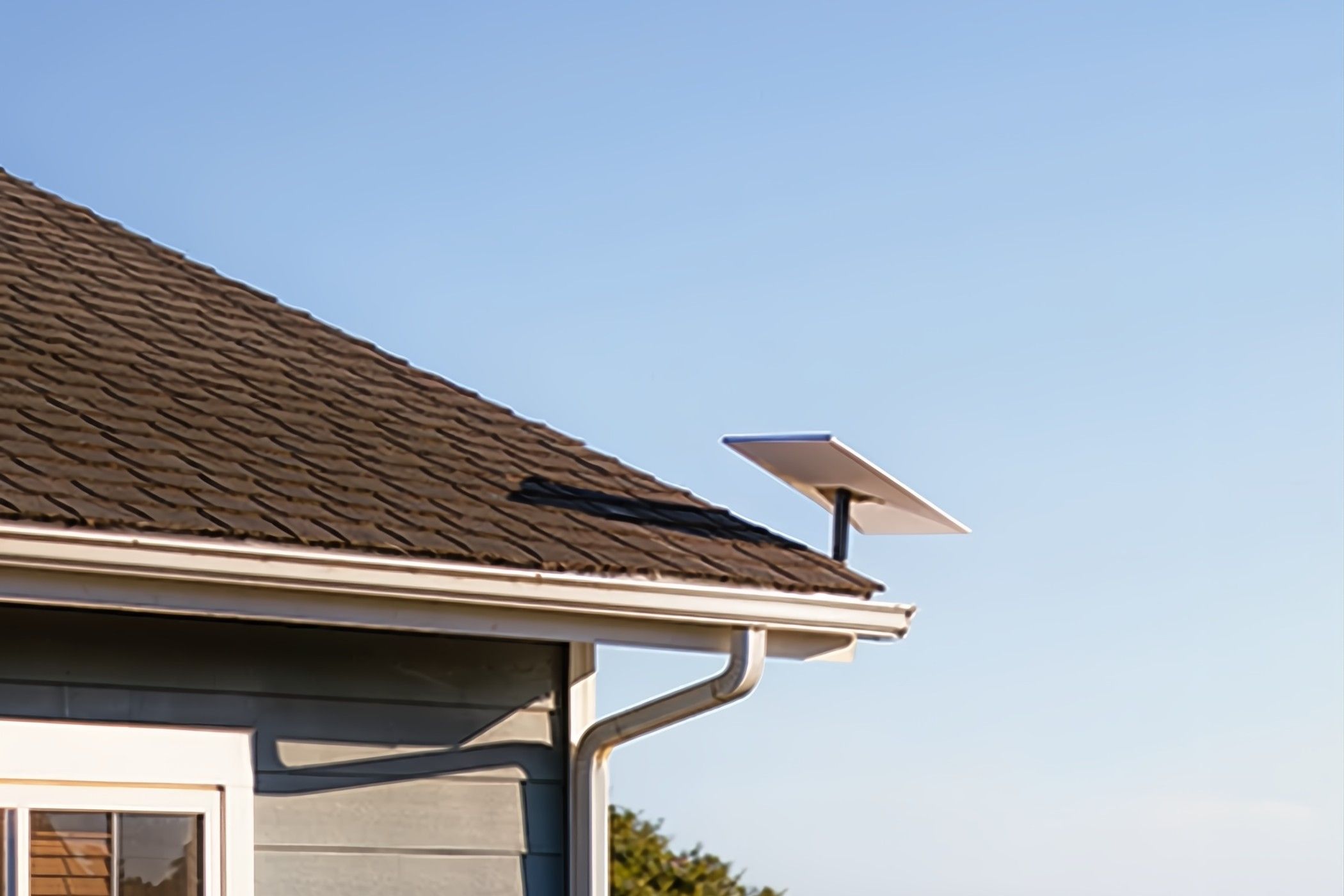 A Starlink antenna on a home's roof