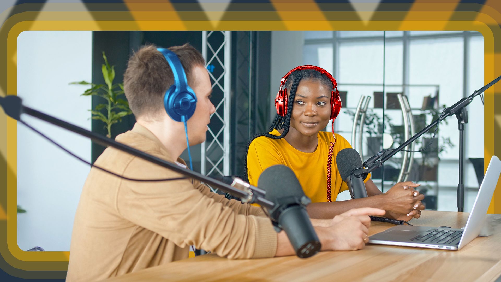 Two people wearing headphones talking on a podcast.