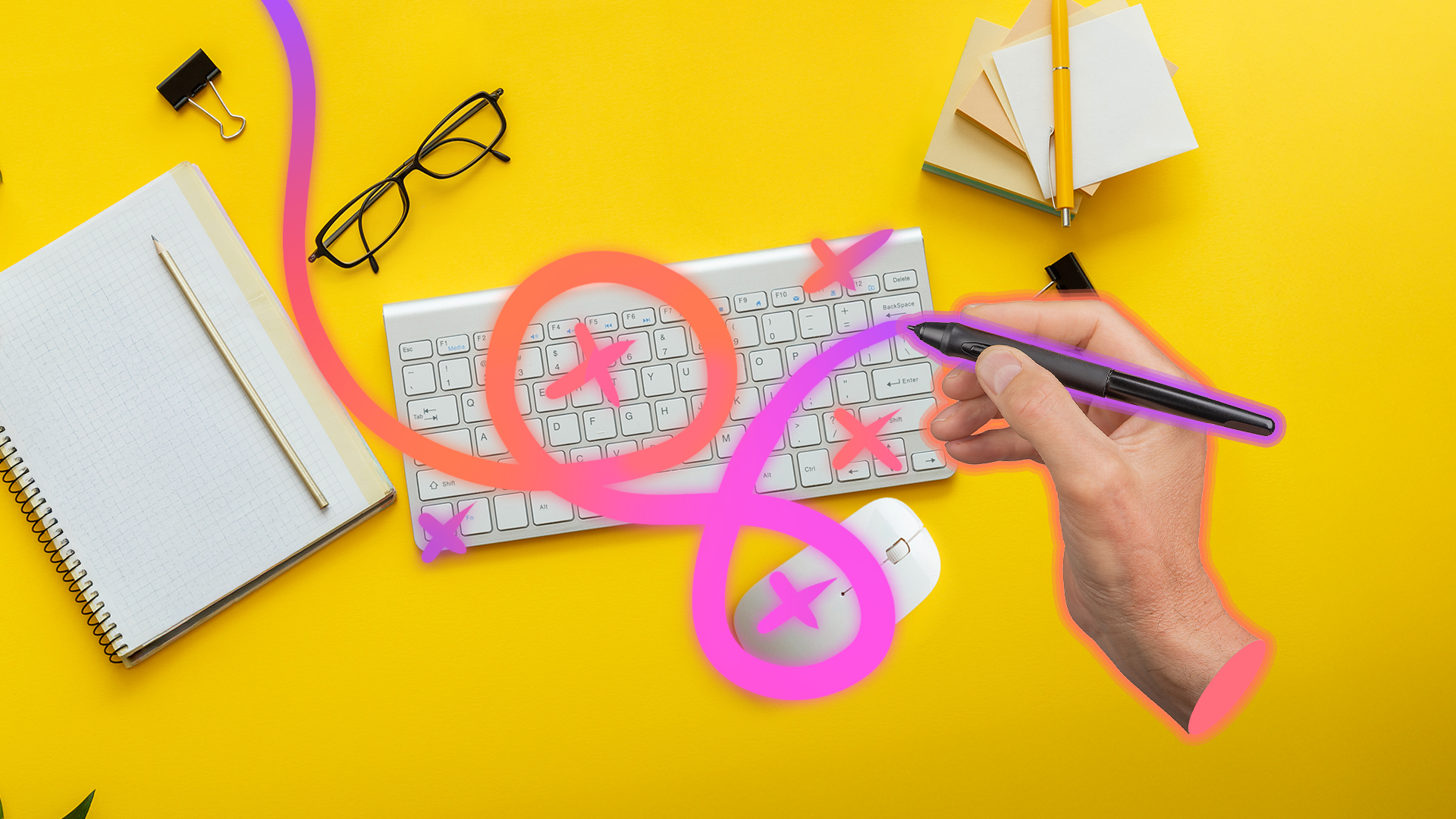 An office desk with a keyboard, mouse, and other items, and a hand holding a stylus pen crossing out the keyboard and mouse.