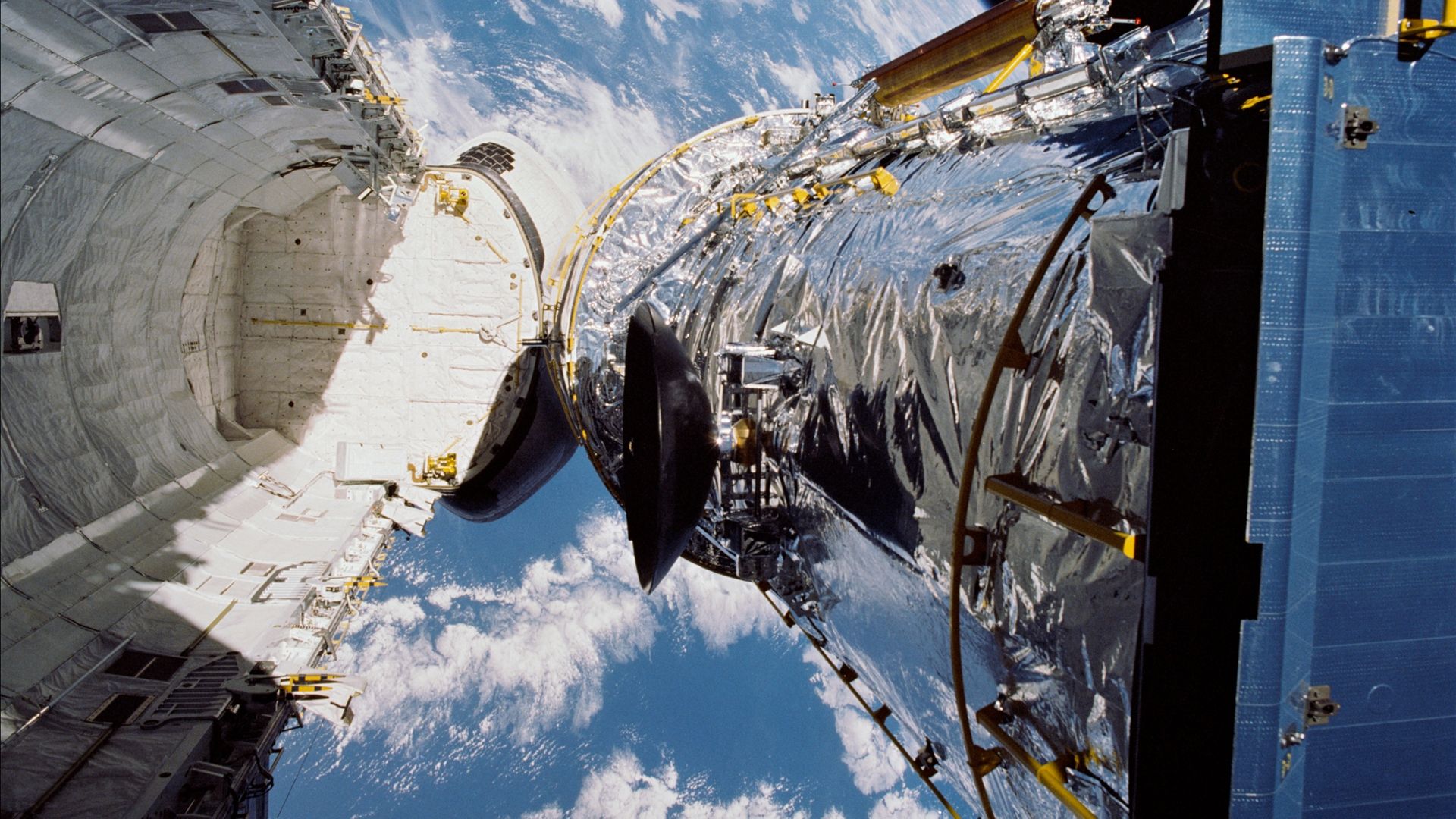 Hubble deploying from the Space Shuttle Discovery.