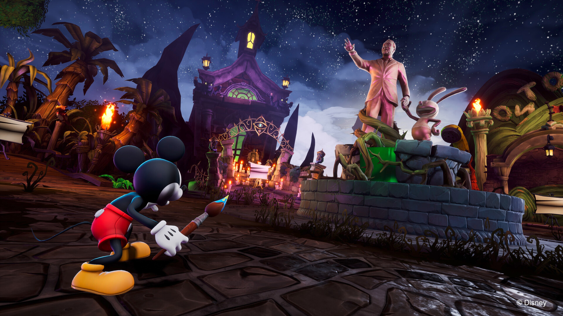 Mickey Mouse holding a magic paint brush, in front of a Walt Disney statue.
