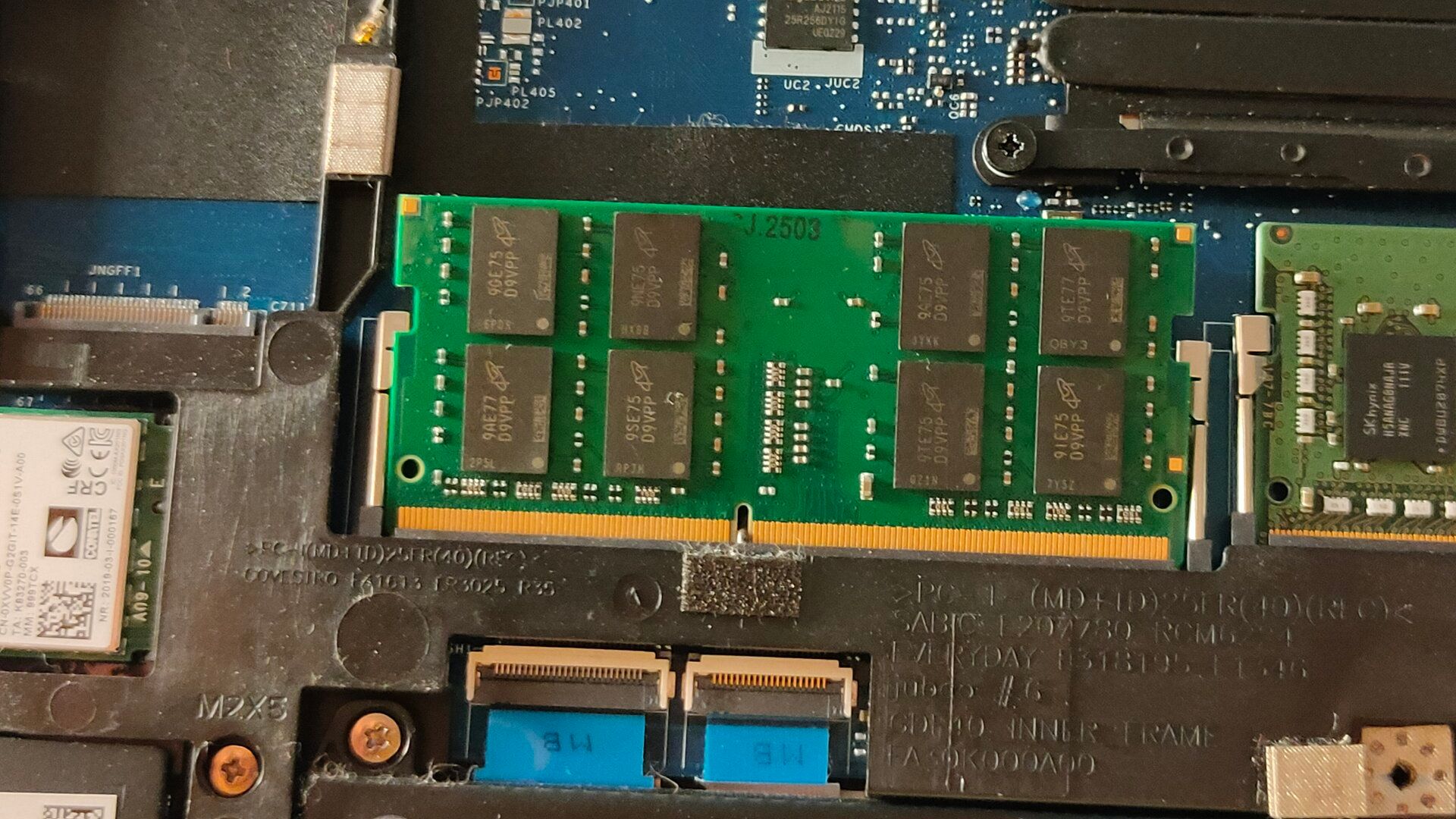 A stick of DDR4 RAM inside of a laptop.