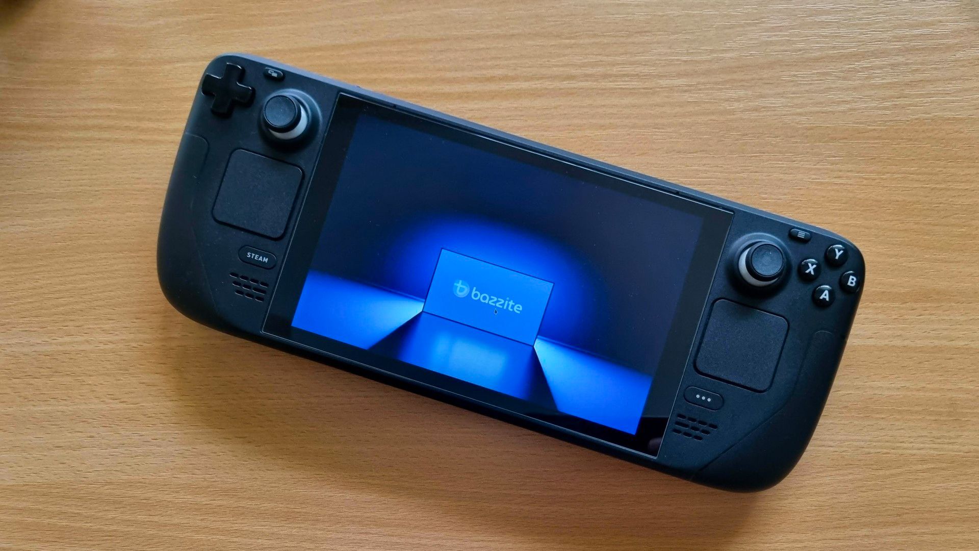 A Steam Deck displaying a Bazzite promo image.