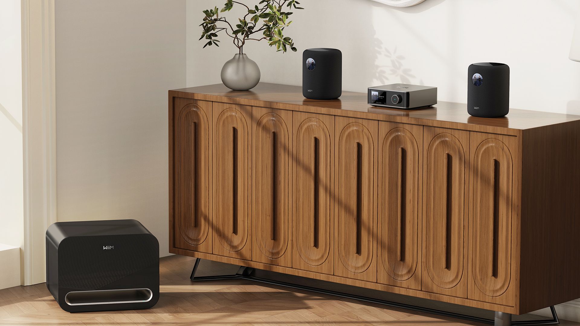A pair of WiiM Sound smart speakers with a Sub Pro subwoofer and Amp Pro amplifier.