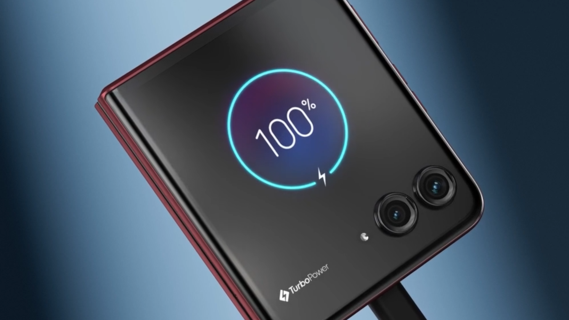 Moto Razr 60 Ultra connected to a wired charger showcasing 100% battery on the cover screen.
