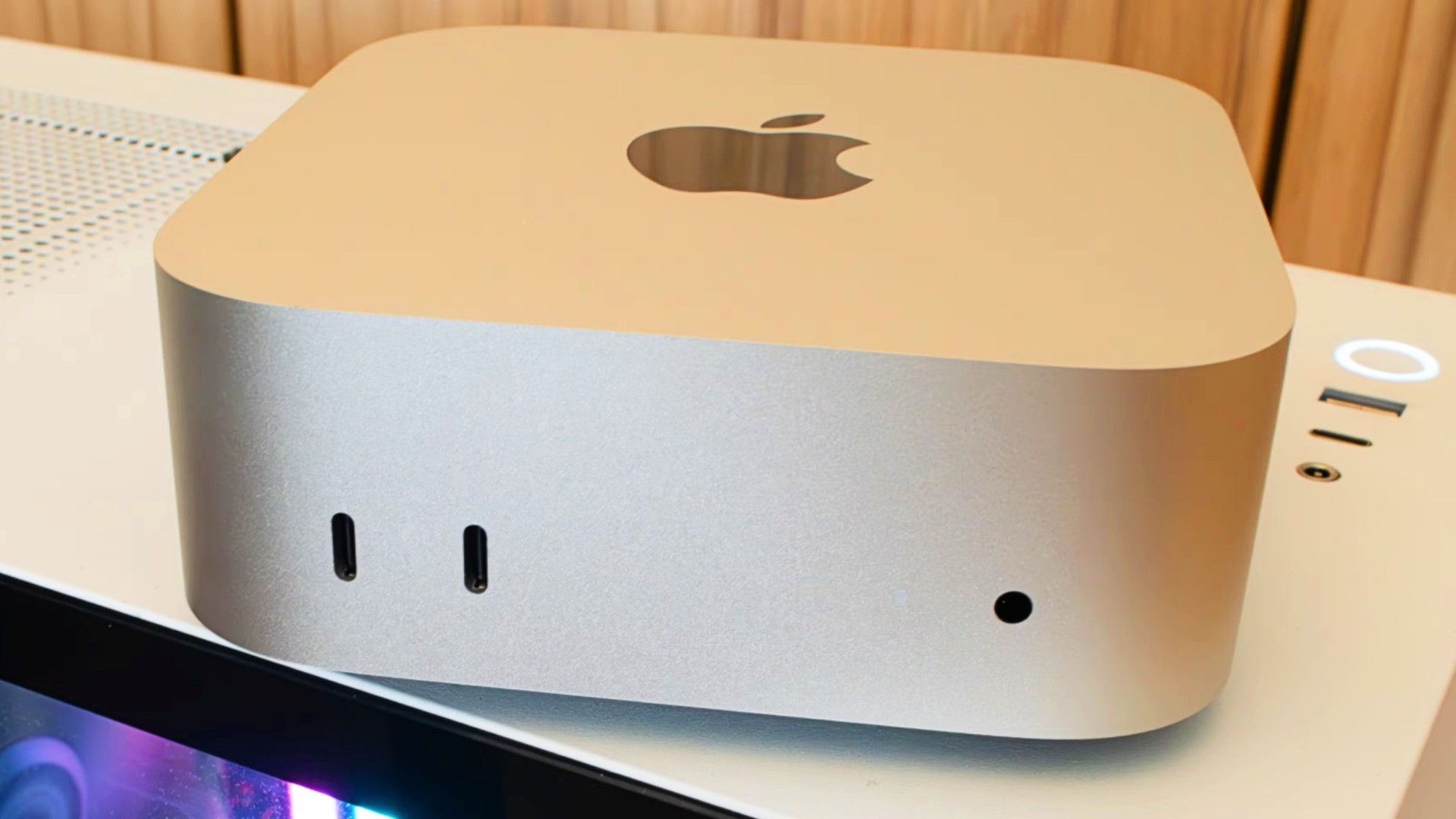 An M4 Mac Mini sitting on top of a PC case.