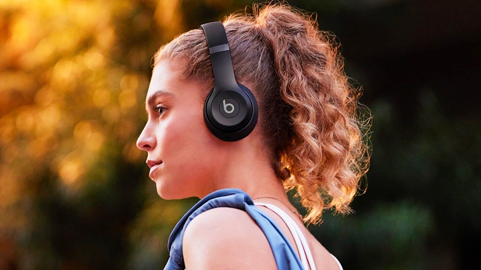 Beats Solo 4 being worn by a woman walking outside