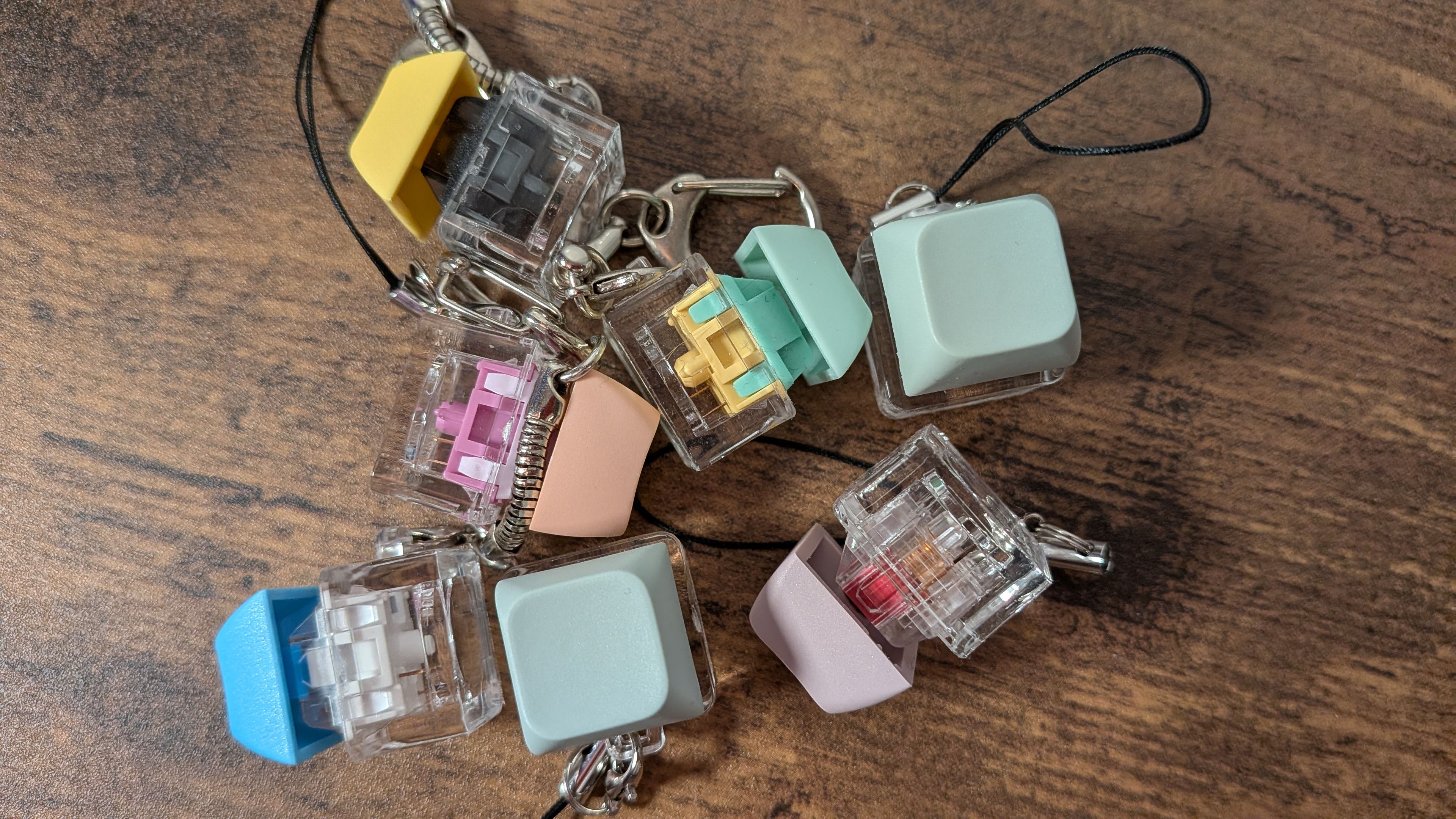 Pile of mechanical switch keychains on a table