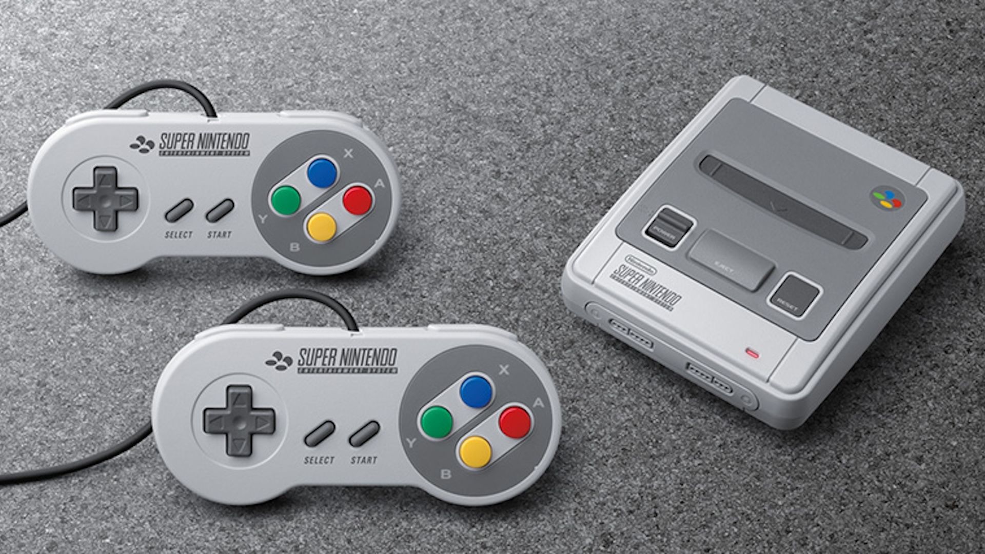 SNES Classic and two controllers on a carpet.
