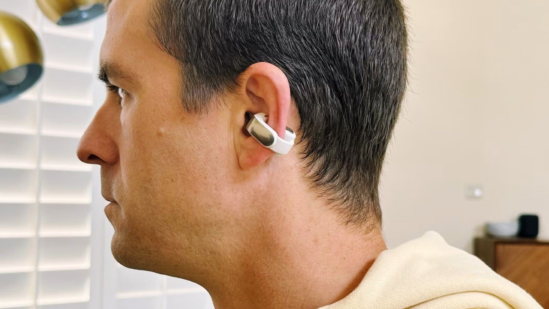 perso wearing bose ultra open earbuds looking forward.