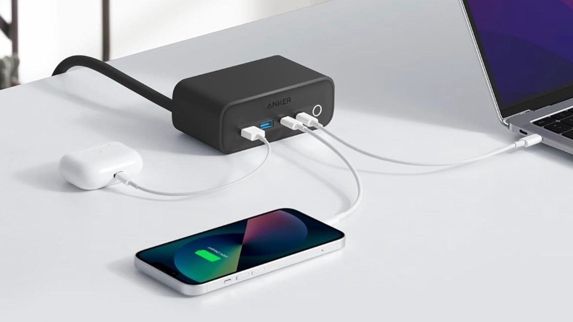 Anker charging station on a desk by a phone