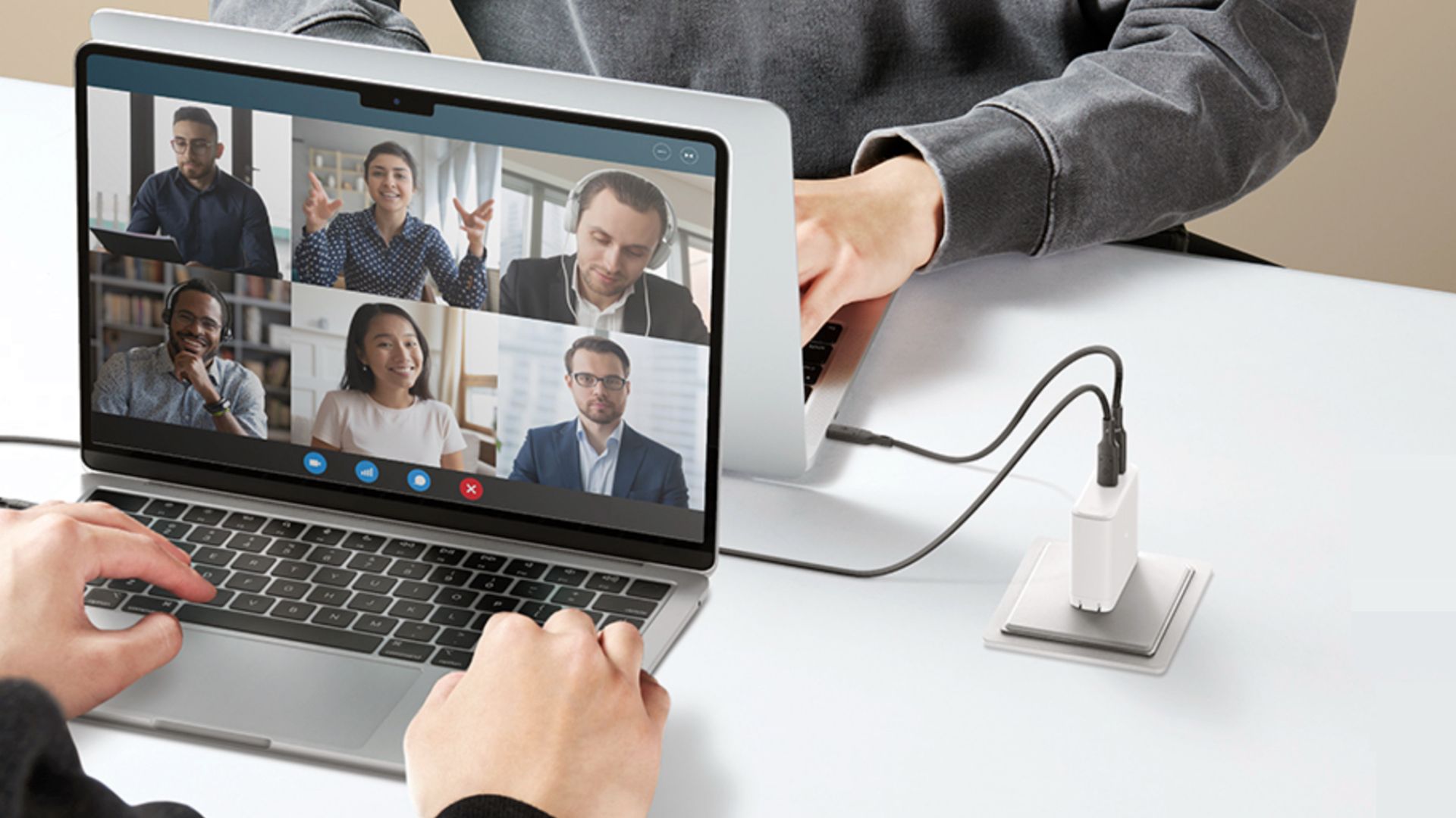 Spigen wall charger powering two laptops.
