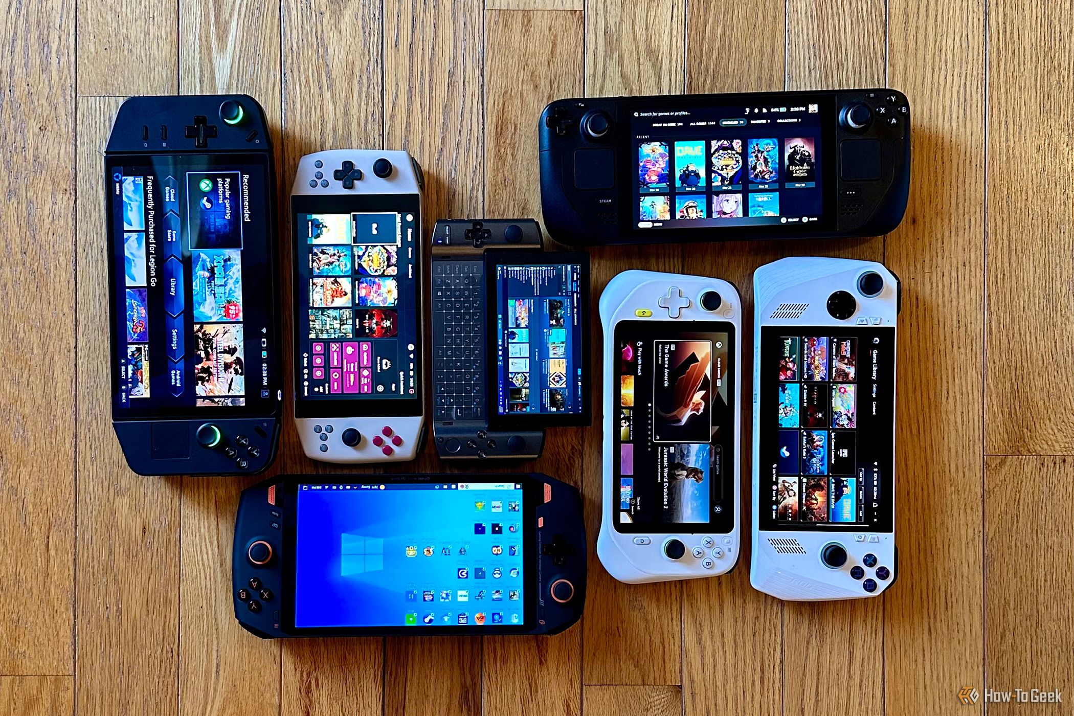 Lenovo Legion Go, AYANEO 2021 Pro, Valve Steam Deck, GPD Win3, Logitech G Cloud, Asus ROG Ally, OneXPlayer 1 on a floor.
