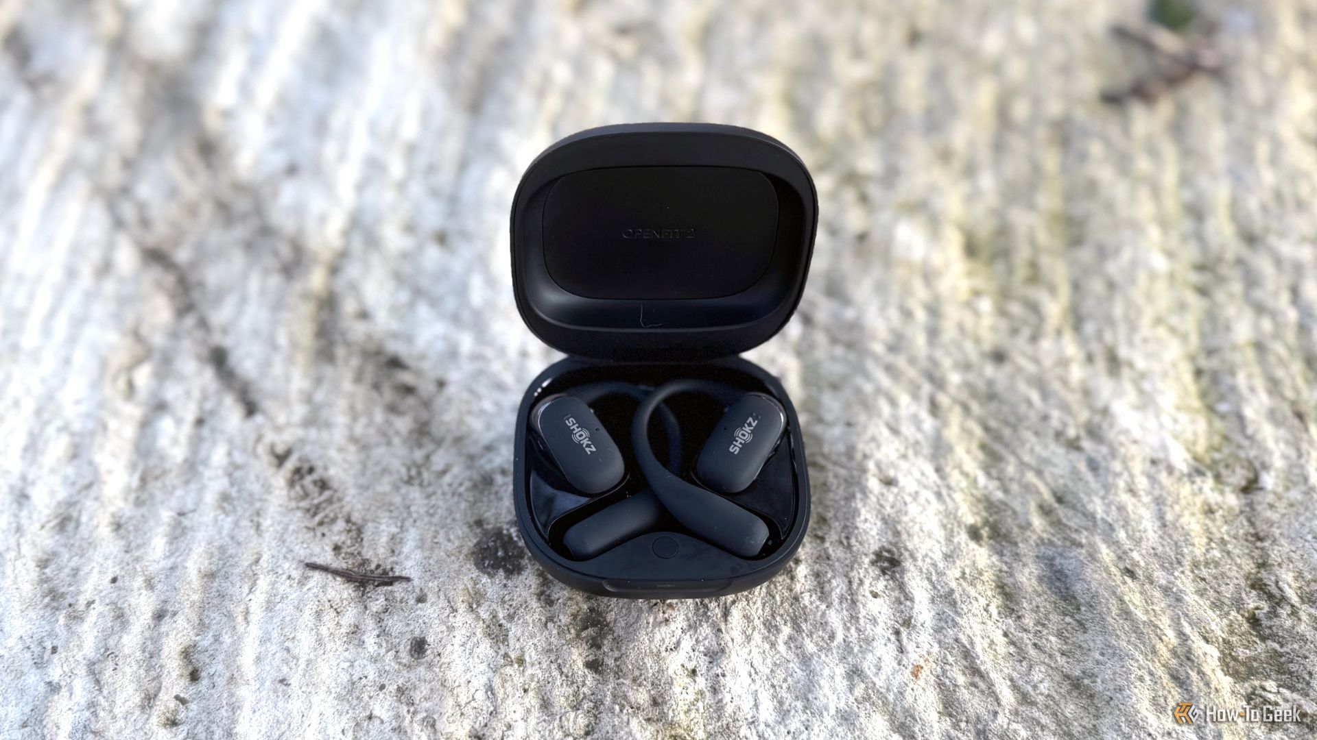 The Shokz OpenFit 2 in the charging case.